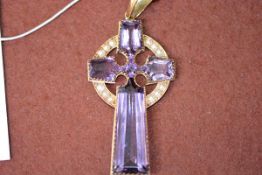 A late 19th/early 20th century Celtic cross amethyst and seed pearl yellow metal mounted pendant,