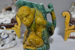 A Continental majolica monkey jug, with branch handle. 17.5cm