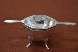 A George VI silver tea strainer on stand, Birmingham 1937, of octagonal form, on hoof feet. 2.7 troy