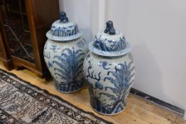 A large pair of Chinese blue and white porcelain covered baluster jars, the domed covers each with