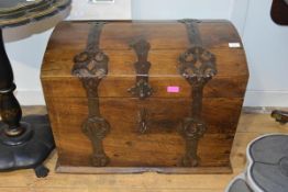 An iron and metal-bound oak dome-topped trunk, fitted with decorative pierced strapwork hinges, with