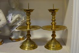A pair of brass pricket sticks in late 17th century style, 19th century, each with cup nozzle on a