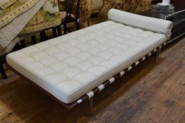 After Ludwig Mies van der Rohe, a Barcelona style day bed, in cream leather with wooden frame and