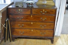 An early 19th century string-inlaid mahogany chest of drawers, the rectangular top above two short