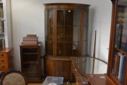 An inlaid mahogany bowfronted vitrine cabinet, in the George III taste, the moulded cornice above an