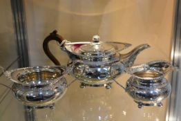 A George V silver three piece tea service, James Dixon & Sons, Sheffield 1917, each piece chased