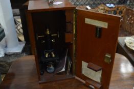 A black lacquer and brass "Service" monocular microscope, W. Watson & Sons Ltd, London, no. 60410,