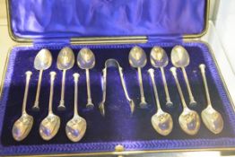 A cased set of twelve George V silver seal-top teaspoons with tongs, C.W. Fletcher & Son,