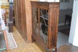 An early 19th century Continental marquetry-inlaid cabinet on stand, with hinged top inside a