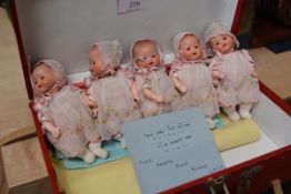 The Dionne Quintuplets: a set of five Armand Marseille bisque head dolls, each in a sprigged smock