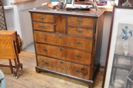 An early 18th century oak and walnut, boxwood-strung chest of drawers, the moulded rectangular top