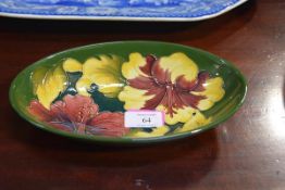 A Moorcroft bowl in the Hibiscus pattern, against a green ground , Walter Moorcroft monogram,