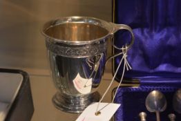 A George V silver Christening cup, Birmingham 1931, cast with a stylised floral band, on a stepped