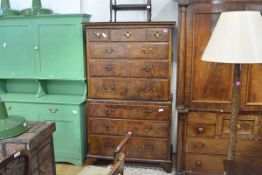 A George II walnut chest on chest, the moulded cornice above three short and three long graduated