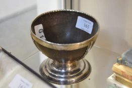 An 18th century silver (unmarked) mounted coconut bowl, the half shell with silver rim above three