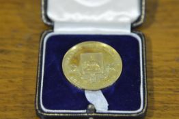 A 9ct gold scholastic medal, Dumbarton Burgh Academy, Dux in Classics, engraved to Robert C.