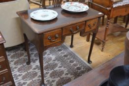 A George III mahogany lowboy, the moulded rectangular top above an arrangement of three drawers