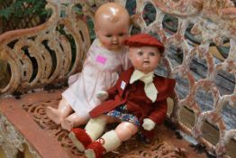 Two German mid-20th century composition dolls, marked "HW..Foreign", each with moulded hair and blue