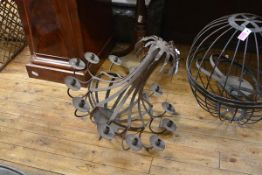 A wrought iron twelve-light chandelier, of basket form, issuing candlearms terminating in sockets