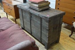 An iron-bound distressed painted chest, the hinged top with decorative metal strapwork, fitted