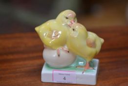 A Herend porcelain group of two chickens, one perched on an egg, printed marks. Height 12cm