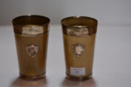 A pair of large Victorian silver-mounted horn beakers, each with silver foot, rim and escutcheon (