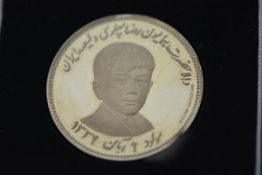 Pahlavi Dynasty, a gold medal, stamped 0.917, commemorating the 9th birthday of the Crown Prince,