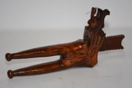 A rare treen nutcracker, probably English, c. 1700, lever action, decorated with trees in leaf and