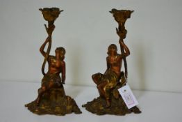 A pair of late 19th century figural lamps each a parcel gilt draped female nude holding a foliate