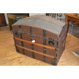A large 19th century dome top travelling trunk, with studded wooden bands, the interior fitted