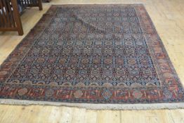 An Isfahan carpet, the centre panel with all over floral and trellis design enclosed within a