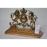 A 19th century brass door stop, cast as the Royal Coat of Arms. 23cm by 31cm