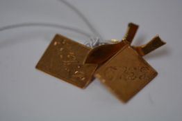 A pair of Indian gold cufflinks, unmarked, each rectangular plate monogrammed and chainlinked to a