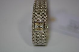 A lady's vintage 18ct white gold wristwatch, by Zenith, the square silvered dial with baton