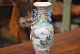 A Chinese porcelain baluster vase, Republican period, painted with a pair of landscape cartouches