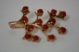 A coral-set gold brooch, designed as a tree, the branches with coral beads, indistinct mark, with