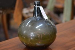 An early 19th century green glass onion form bottle, with oval gilt painted cartouche. Height 24cm