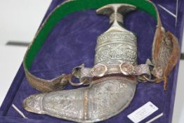 An Arab Jambiya, 20th century, of characteristic form, mounted in white metal (possibly silver?),