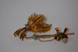 A diamond-set 18ct yellow gold brooch, modelled as three feathers; together with a yellow metal