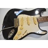 A Fender Squier Stratocaster guitar, 1980's, serial no. E641604, Made in Japan, black body with