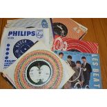 A group of approximately twelve Beatles and Rolling Stones 45's including two French Odeon,