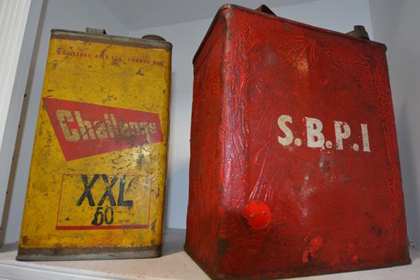 Two vintage oil cans, Challenge Oil and another marked SBPI (2)