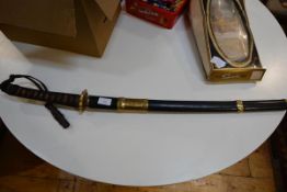 A 20th century Japanese katana, of characteristic form, in a leather scabbard