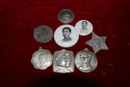 A small group of Chinese Communist white metal medallions and two badges including one inscribed "To