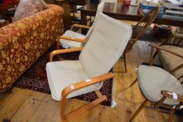 A pair of beech laminate armchairs