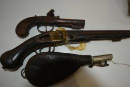 Two 18th/19th century pistols (incomplete) together with a leather powder pouch