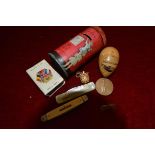 A group including a tin pillar box money bank, Mauchline type egg sewing kit; World War I