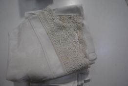 A group of late 19th/early 20th century cloths comprising a table cloth with deep crochet border,