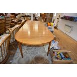 A vintage Troeds (Sweden) teak extending dining table, with d-ends and two leaves, raised on