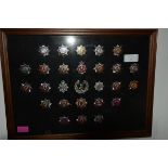 A framed group of largely Fire Brigade badges including Glasgow, Central, Strathclyde, Fife etc (